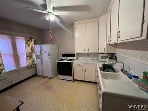 kitchen with light countertops, a ceiling fan, white cabinetry, and white appliances
