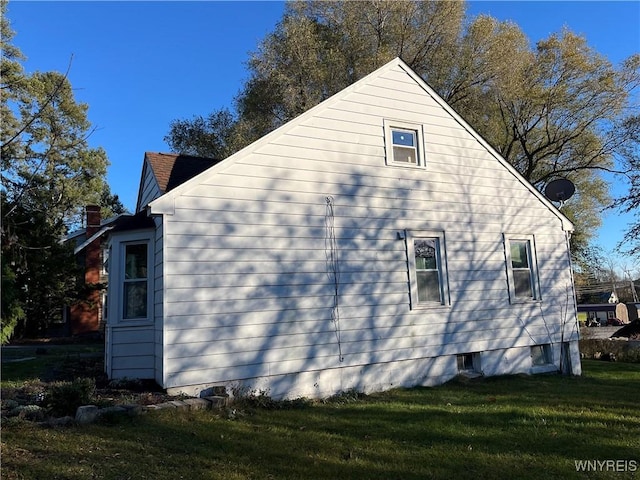 view of home's exterior with a yard