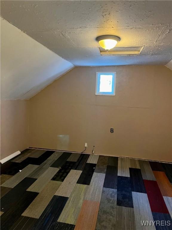 bonus room featuring wood finished floors and lofted ceiling