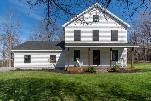 view of front of house featuring a shingled roof, a porch, and a front lawn