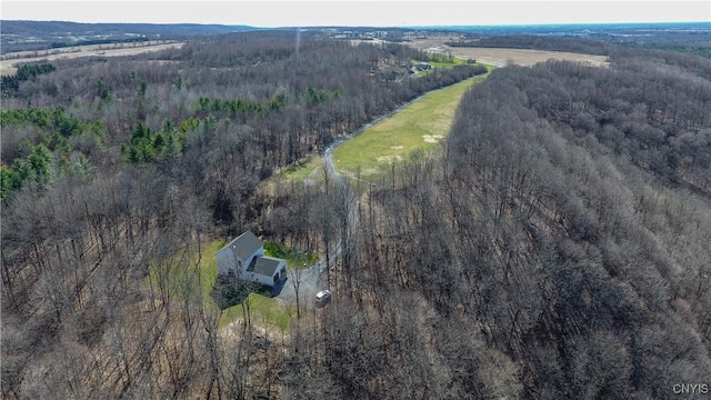 birds eye view of property featuring a view of trees