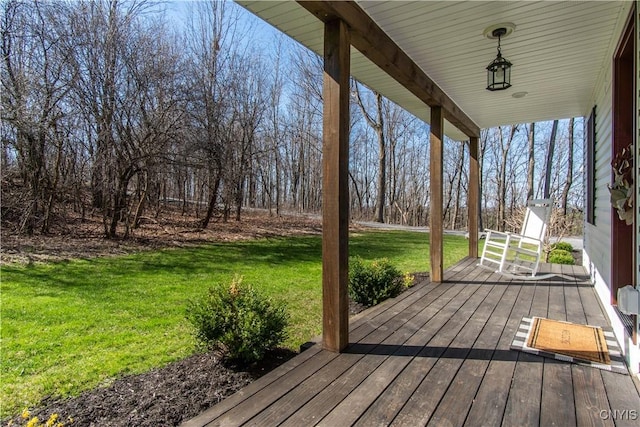 wooden deck with a porch and a yard