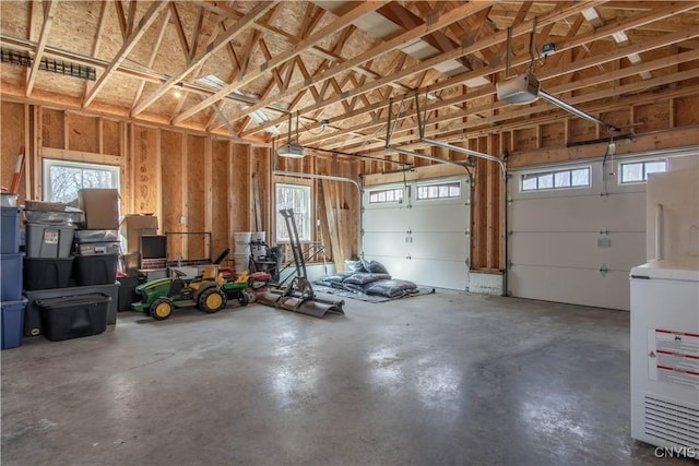 garage with a garage door opener and fridge