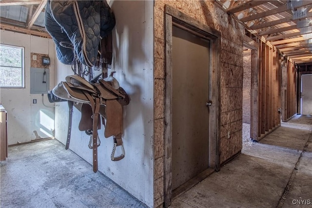 interior space featuring unfinished concrete floors and electric panel