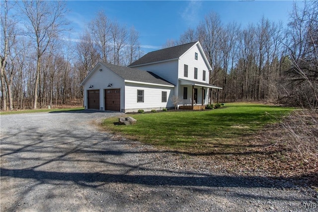 view of side of home with a porch, a garage, a lawn, roof with shingles, and gravel driveway