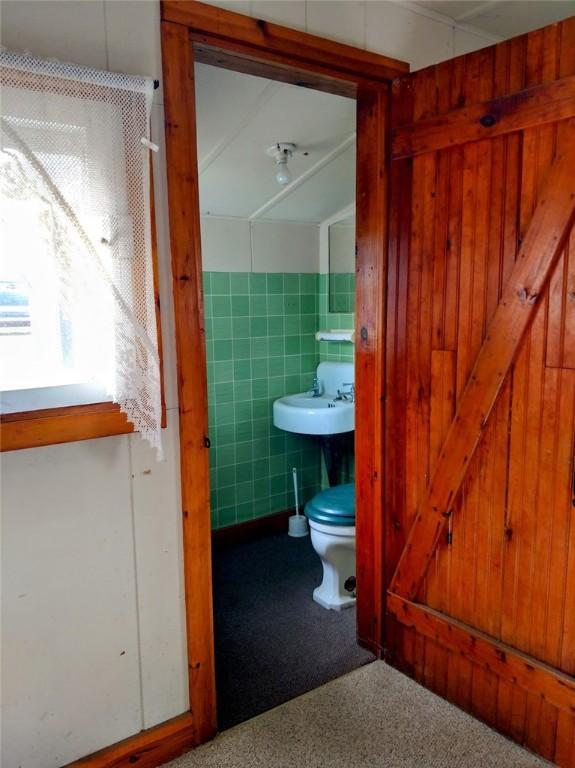 bathroom with tile walls