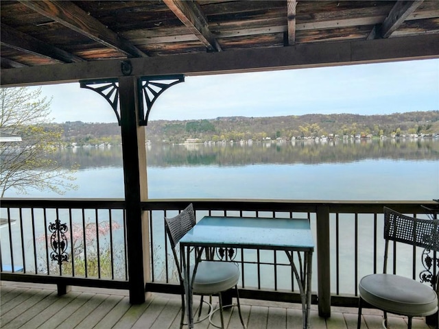 dock area featuring a water view and a balcony