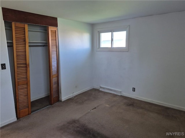 unfurnished bedroom featuring baseboards, visible vents, carpet, and a closet