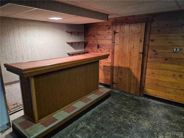 bar with a dry bar and wood walls