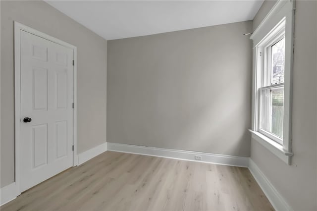 unfurnished room featuring light wood finished floors and baseboards