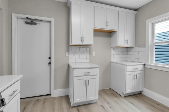 kitchen featuring light wood-style floors, tasteful backsplash, and light countertops