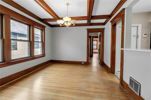 unfurnished room featuring a wealth of natural light, visible vents, a chandelier, and baseboards