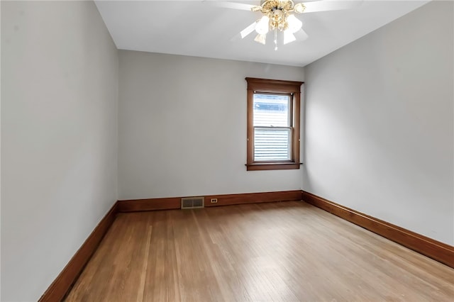 unfurnished room with baseboards, visible vents, a ceiling fan, and light wood finished floors