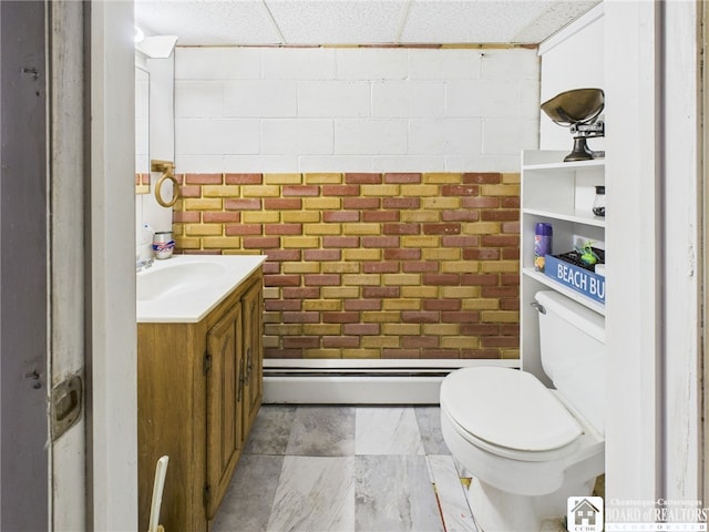 bathroom with a baseboard heating unit, toilet, and vanity