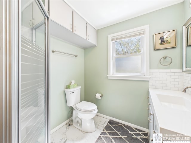 bathroom featuring toilet, marble finish floor, vanity, and baseboards