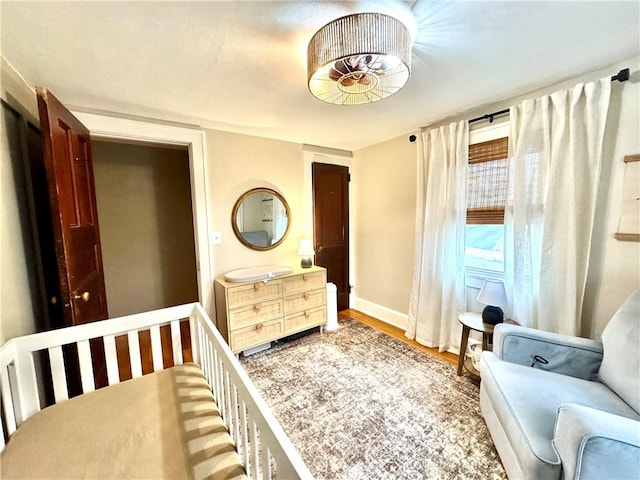 bedroom featuring baseboards and wood finished floors