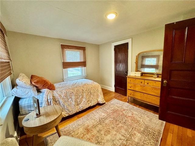 bedroom with wood finished floors and baseboards