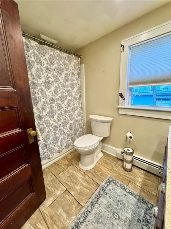 full bath featuring toilet, a shower with shower curtain, a baseboard radiator, and baseboards