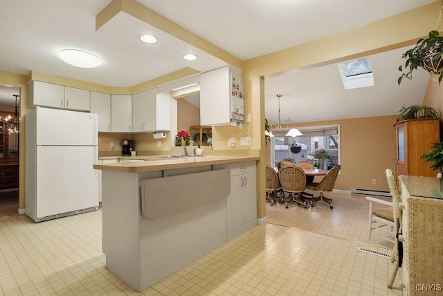 4969 Look Kinney Cir, Clay, NY 13088 - kitchen with freestanding refrigerator, recessed lighting, a baseboard heating unit, light countertops, and a skylight