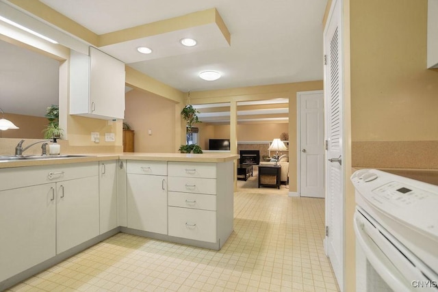 4969 Look Kinney Cir, Clay, NY 13088 - kitchen with a sink, a peninsula, recessed lighting, light countertops, and white range with electric stovetop