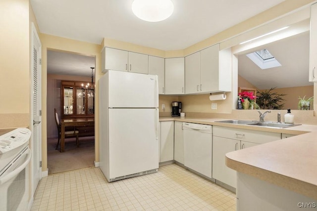4969 Look Kinney Cir, Clay, NY 13088 - kitchen featuring a sink, a skylight, white appliances, an inviting chandelier, and light countertops