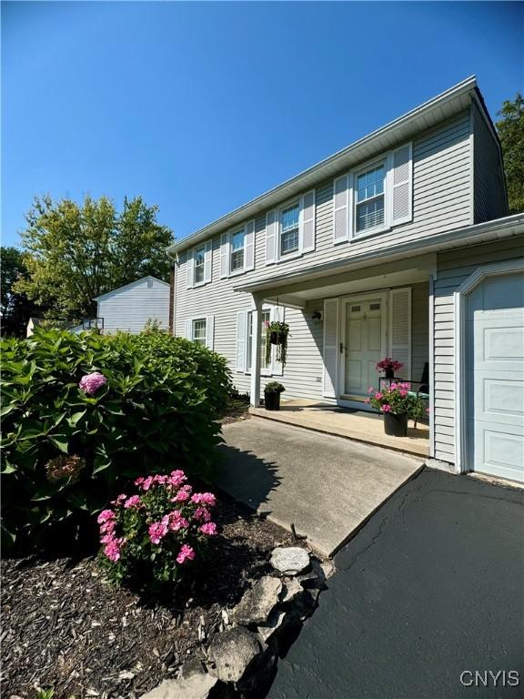 4969 Look Kinney Cir, Clay, NY 13088 - view of front of home featuring a porch