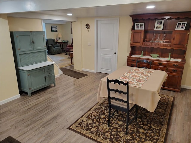 dining space with light wood-type flooring, recessed lighting, and baseboards