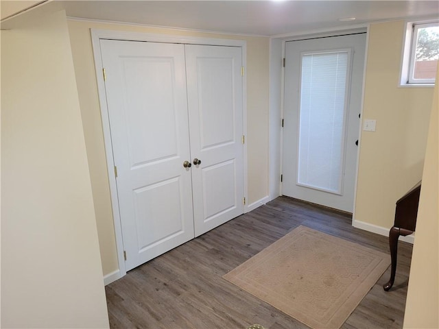 entrance foyer featuring baseboards and wood finished floors