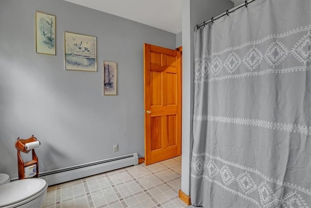 394 Nersesian Rd, Otsego, NY 13348 - bathroom with a baseboard heating unit, toilet, and a shower with curtain