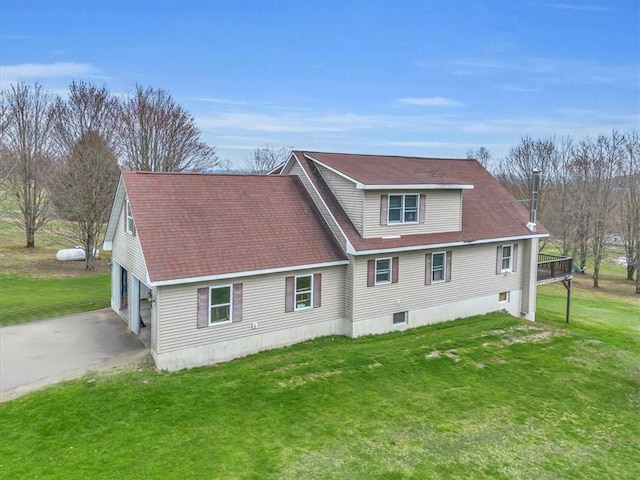 394 Nersesian Rd, Otsego, NY 13348 - rear view of property featuring a lawn, a shingled roof, and driveway