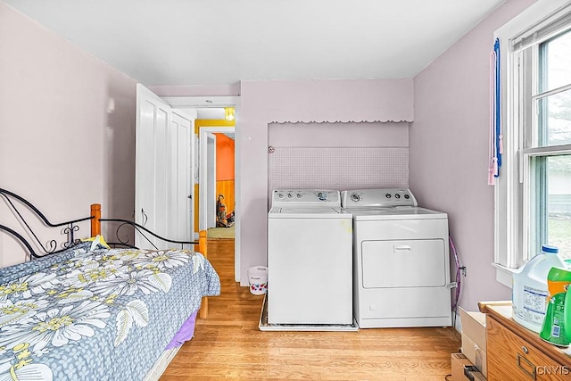 laundry room featuring washer and dryer, laundry area, and light wood-style floors