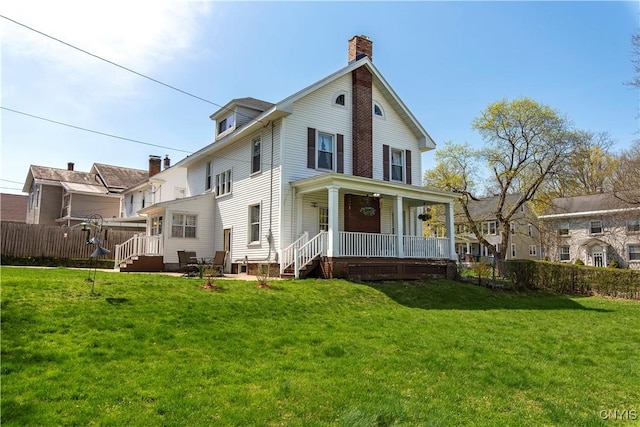 117 Proctor Blvd, Utica, NY 13501 - rear view of property with a porch, a lawn, fence, and a chimney