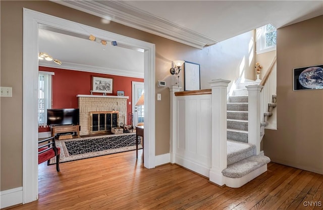 117 Proctor Blvd, Utica, NY 13501 - stairs with ornamental molding, a fireplace, baseboards, and wood-type flooring