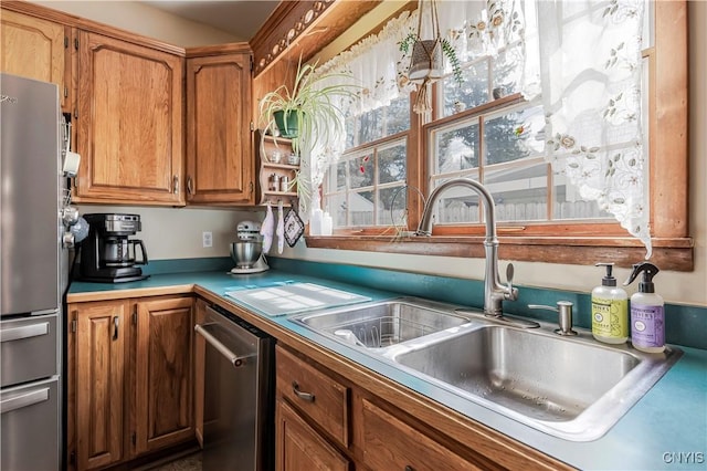 117 Proctor Blvd, Utica, NY 13501 - kitchen with stainless steel appliances, light countertops, brown cabinetry, and a sink