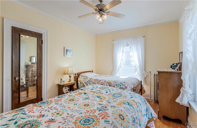 117 Proctor Blvd, Utica, NY 13501 - bedroom with ornamental molding, radiator, a ceiling fan, and light wood-style flooring