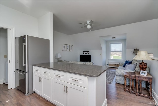kitchen with light wood-style floors, freestanding refrigerator, and open floor plan