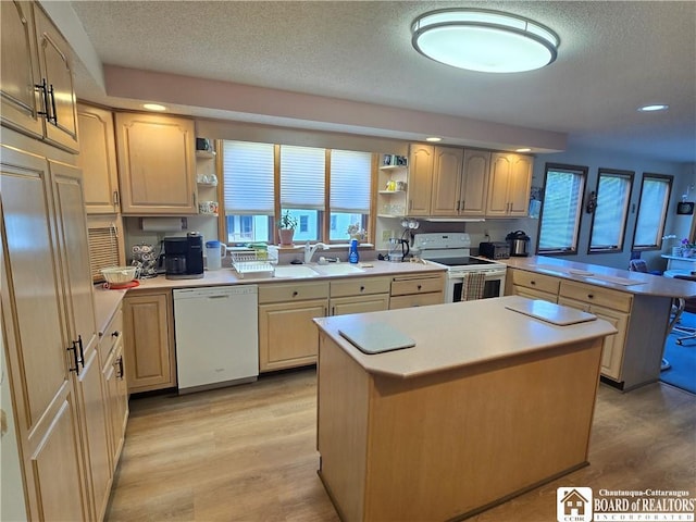 kitchen with open shelves, a sink, light wood-type flooring, white appliances, and a peninsula