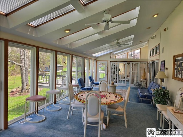 sunroom featuring a ceiling fan, carpet floors, and a healthy amount of sunlight