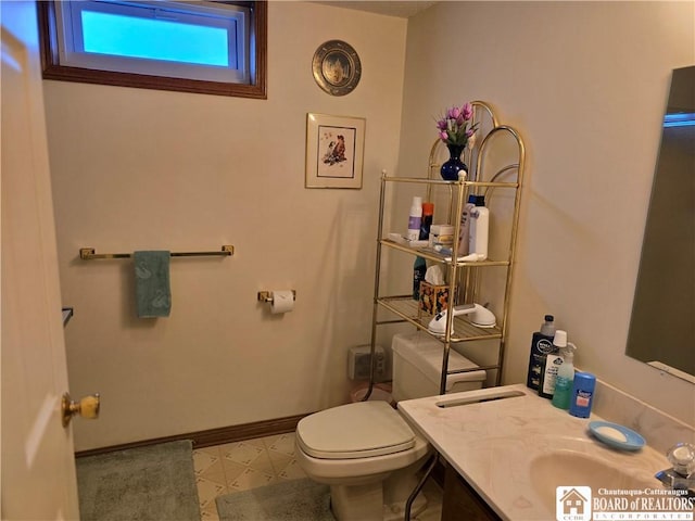 bathroom with tile patterned floors, vanity, toilet, and baseboards