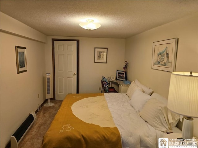 bedroom featuring a textured ceiling and carpet