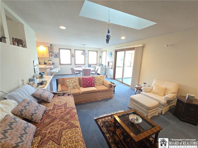 living area with recessed lighting, a skylight, carpet flooring, and a textured ceiling