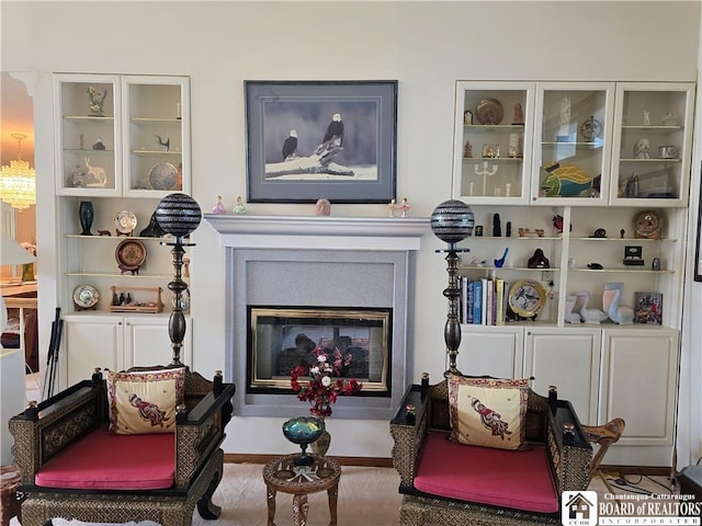living area with a glass covered fireplace