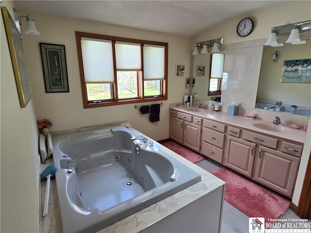 bathroom with double vanity, a whirlpool tub, lofted ceiling, and a sink