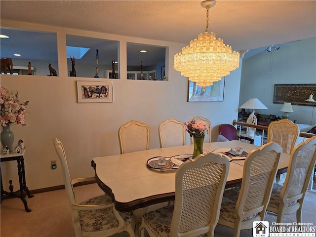 carpeted dining area with a chandelier and baseboards
