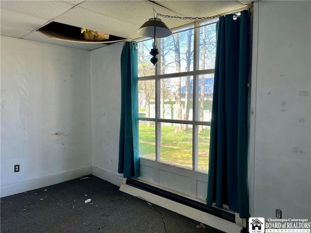 empty room featuring baseboard heating and baseboards