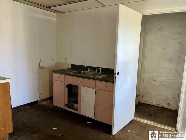 kitchen with dark countertops and a sink
