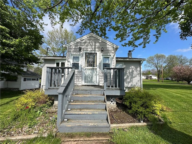 48 King St, Mentz, NY 13140 - back of house featuring a lawn, a chimney, and a deck