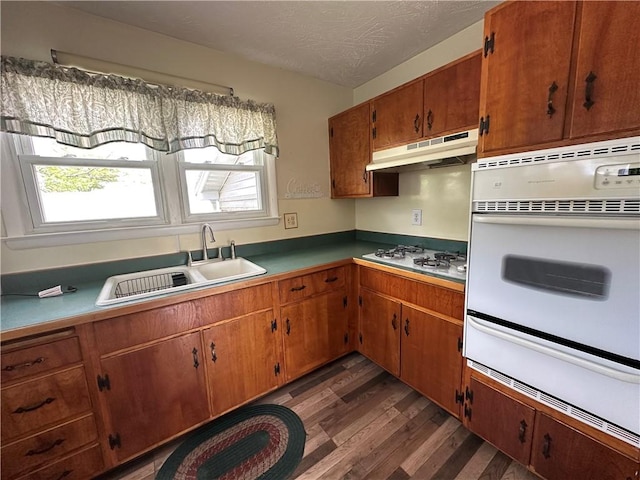 48 King St, Mentz, NY 13140 - kitchen with white appliances, under cabinet range hood, a sink, a warming drawer, and dark wood-type flooring