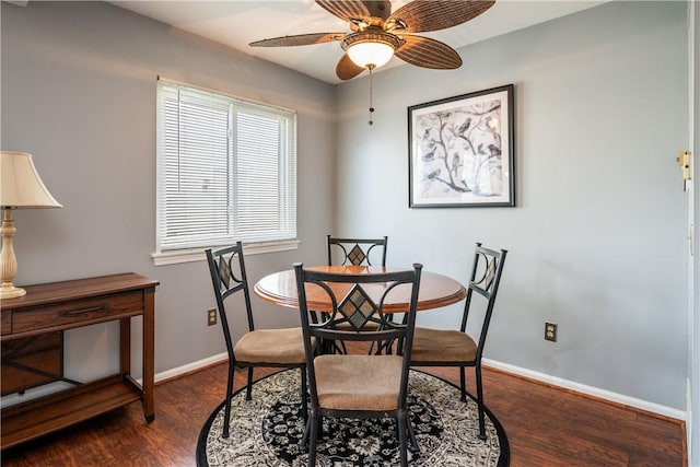 dining area with dark wood-style floors, baseboards, and a ceiling fan