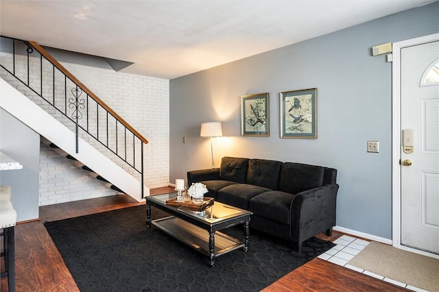 living room with stairway and wood finished floors